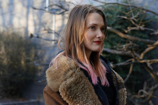 Portrait Of Woman With Pink Tipped Blonde Hair Wearing A Brown