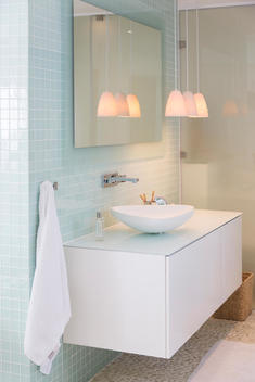 Sink, mirror and lamps in modern bathroom