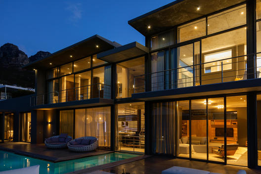 Luxury house with swimming pool illuminated at night