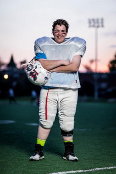 Portrait of a women\'s football player on the field during an evening practice.