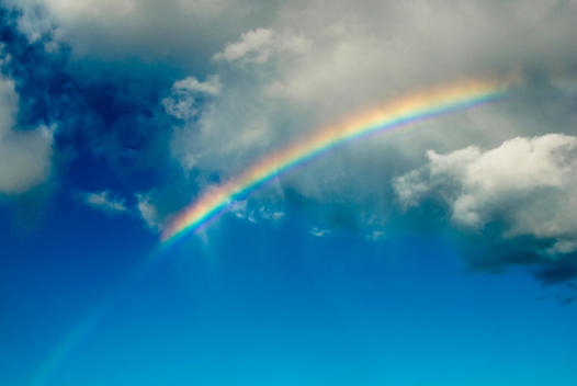 Rainbow In The Sky With Clouds