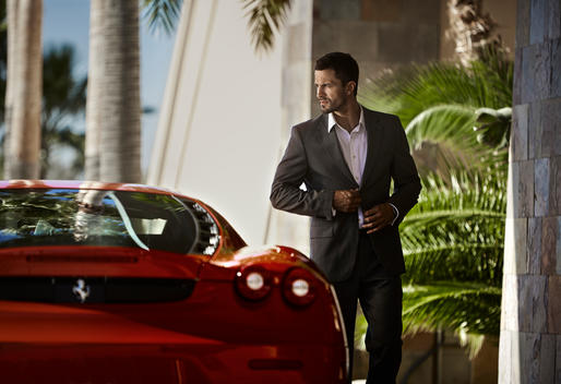 Man walking to luxury red car.