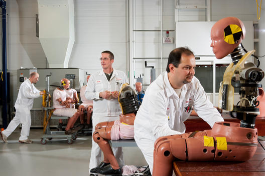 Scientists at the Honda crash test lab put together and maneuver dummies used in the tests