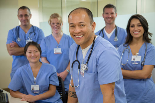 Nurses and doctors smiling together in hospital