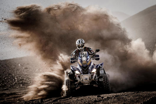 Dakar rally four track turning in the sand