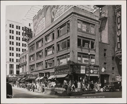 The Northwest Corner Of 49Th Street And Seventh Avenue. Numerous Storefronts Are Visible. Men Fixing The Street Are Also Visible.