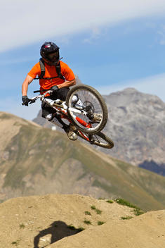 Italy, Livigno, View of man jumping with mountain bike