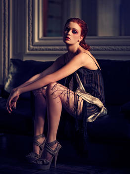 Portrait Of Fashionable Woman Sitting On Sofa
