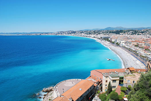 Mediterranean beach in Nice, showing turquoise sea and hotels along the beach. France, Cote d\'Azur, Alpes-Maritimes, Provence-Alpes-Cote d\'Azur.