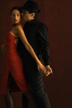 Couple tango dancing, holding hands, side view