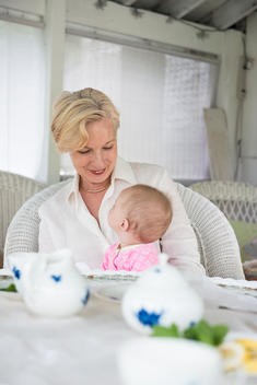 Portrait of a grandmother and granddaughter at a table set for tea