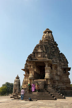Hindu believers at ancient stone carved Hindu temple at the Kama Sutra temple grounds of Khajuraho