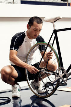 Student fixing his bike at the Japan bicycle racing school