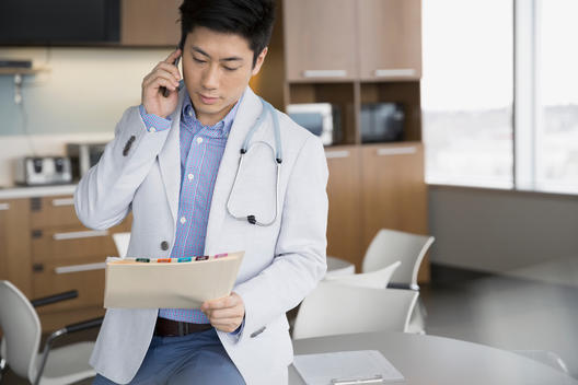 Doctor reviewing medical charts in break room
