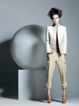 Fashion Story Based On A Theme With Spheres Of Various Sizes In A Studio Surrounding, Model Standing Beside Sphere On Cube