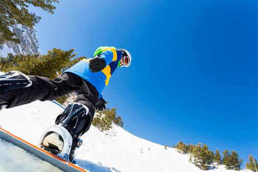 9 year old boy snowboarding down run off of Strawberry Express Gondola at Snowbasin Resort.