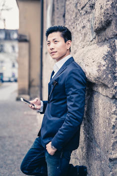 Asian business model with jacket facing into camera