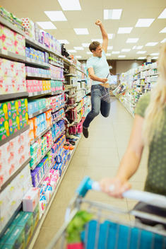 Man jumping for joy in grocery store