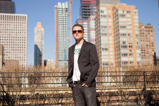 Portrait of business and tech entrepreneur Casey Kerr in sunglasses on the rooftop popular hotel Pod 51 with view of midtown east Manhattan. NYC