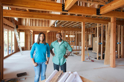 Black couple standing in unfinished room