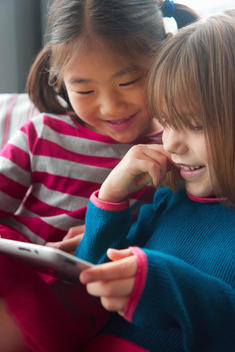 Young Girls Using Digital Tablet Smiling