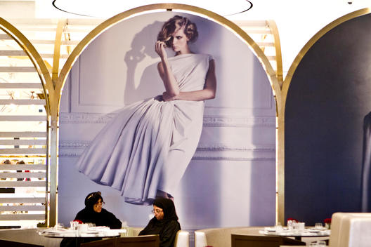 Emirati women sitting at a table in the Vogue Cafe in the Dubai Mall