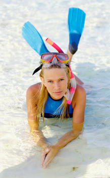 Portrait of woman snorkeler lying in sea
