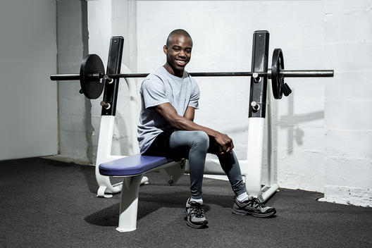 Portrait of a young African-American man with cerebral palsy working out at a gym.