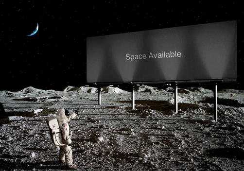Astronuat On The Moon Pointing At A Billboard With The Text 