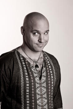 Portrait of a 44 year old bald man wearing an ethnic-looking shirt