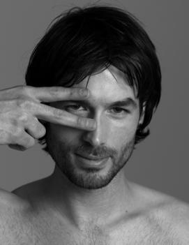 Portrait Of Male Model Holding Fingers Over Eye
