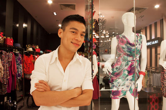 Nguyen Pham Anh Tuan (Adrian), a top Vietnamese fashion designer, stands outside his shop in downtown Saigon.