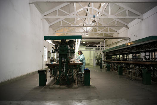 A silk-factory employee working on an assembly line in China.