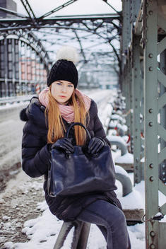 Portrait of young woman in winter outfit on her way to work in the city