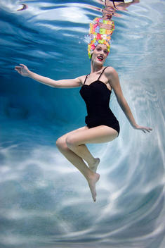 Mixed race woman swimming underwater