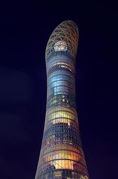 Detail shot of the \'Aspire tower\' (Torch Hotel) illuminated at night.