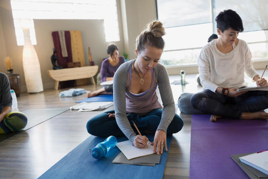 Women with journals at restorative yoga retreat