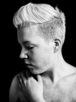 Woman with mohawk haircut and freckles, close up