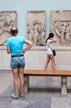 Two people looking at sculptures in the Pergamon Museum, Berlin