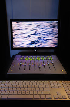 A computer workstation with sound board in a home recording studio