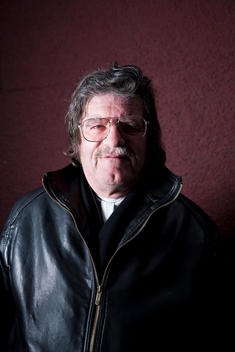 Overweight Man Wearing Glasses And Black Leather Jacket