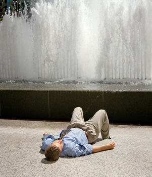 Businessman Sleeping In Front Of Fountain, Chicago