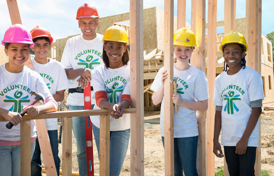 Volunteers building house together