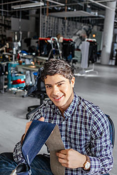 Portrait of confident male worker in jeans factory