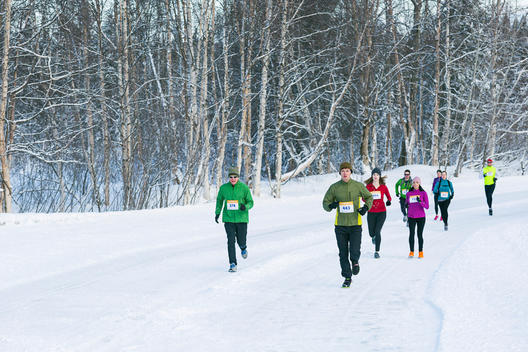 A group of runners competing during a winter road race.