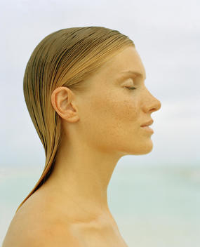 profile of girl with wet hair on beach