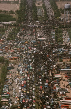 Tehran, Iran June 6, 1989 Mourners move towards the burial site for the funeral for the Grand Ayatullah Sayid Ruhullah Musawi Khomeini at the Beheht-E-Zahra cemetery. His body is flown in by helicopter to this site but frenzied crowds prevent the first at