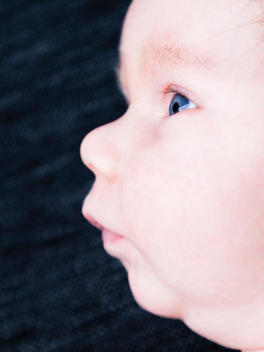 Side profile of a 2 week old baby boy.