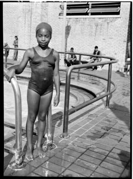 Child Standing At The Edge Of Colonial Park Swimming Pool.