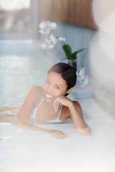 Woman smiling in hot tub at spa